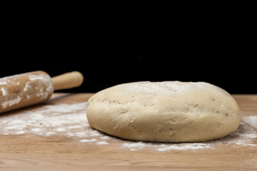 Fototapeta na wymiar Dough on flour covered board.
