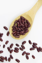 Fototapeta premium Red bean on wooden spoon on white background
