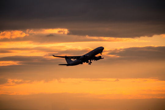 Silhouette of airplane at sunset