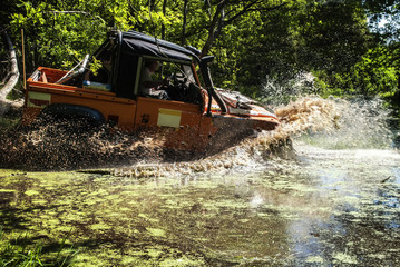 Land Rover driving through a lake