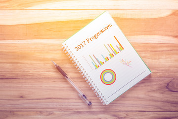 Top view year 2017 with notebook on wooden desk