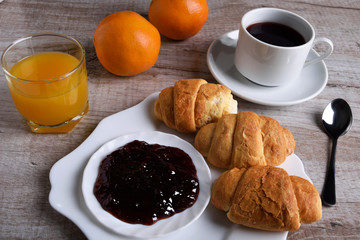 light breakfast. juice and croissants with jam and tea