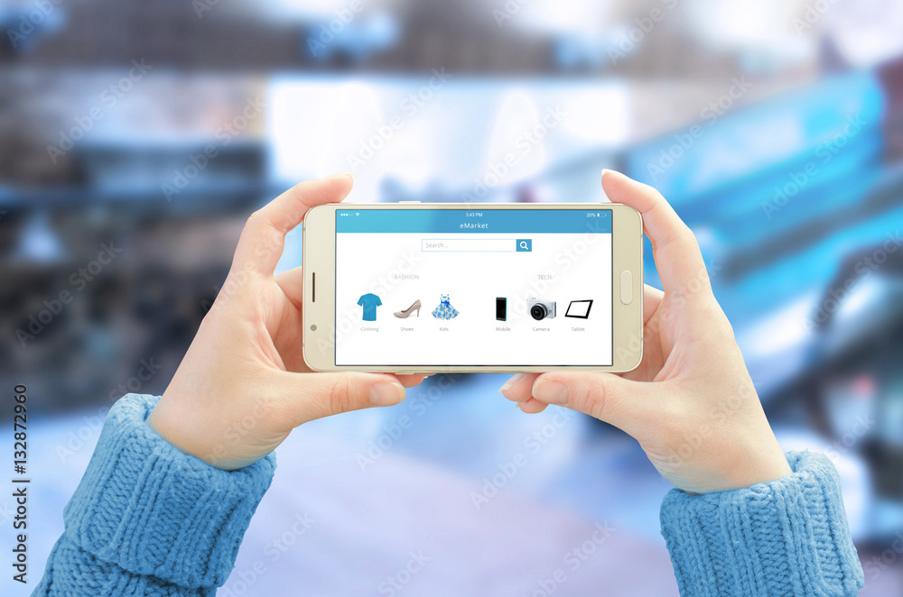 Poster Phone in horizontal position in woman hands. Commerce app with modern user friendly interface on mobile display. Business center in background.