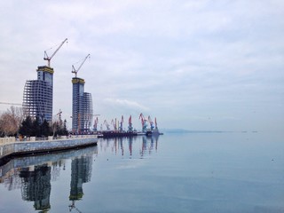 Fototapeta premium Embankment with construction site and cranes at a port