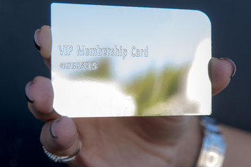 holding a silver vip card