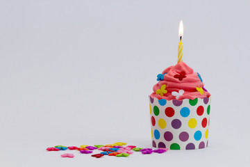 colorful cupcake with yellow candle