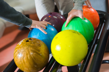 Fototapeta na wymiar Three friends choosing their bowling balls