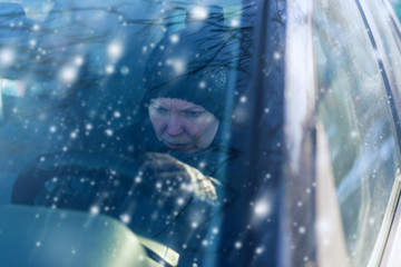 Woman can not start car on cold snowy winter day