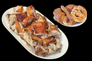 Plateful of Spit Roasted Pork Slices and Pretzel with Bunch of Croissant Sesame Puff Pastry Isolated on Black Background                