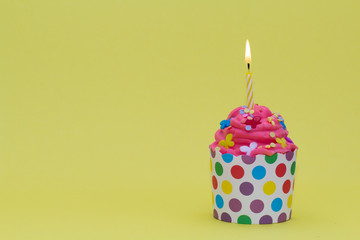 delicious cupcake with red cream and candle