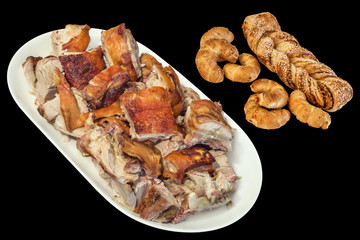 Plateful of Spit Roasted Pork Slices with Sesame Croissant Puff Pastry Braid and Rolls Isolated on Black Background