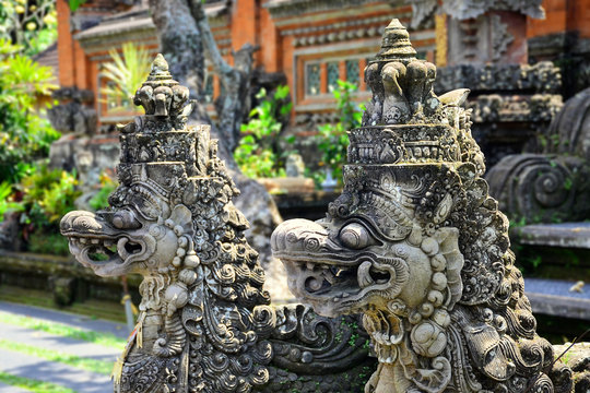 Ancient stone statue of a balinese Barong Naga in Ubud, Bali. Barong is the demon queen and mother of all spirit guards in the mythology of Bali