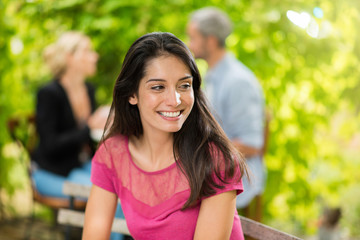 Portrait of a beautiful brunette sitting at a terrace cafe