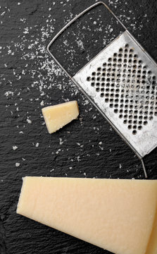Parmesan cheese with a grater.Cocnept proces with food . Grater cheese