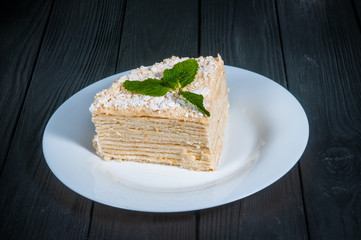 Delicious cake on a wooden black background