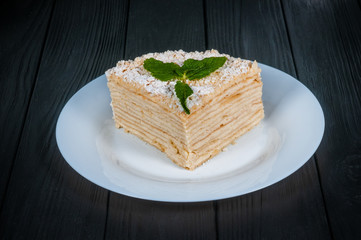 Delicious cake on a wooden black background