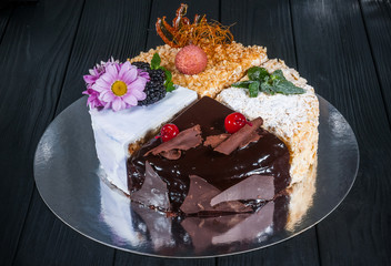 Delicious cake on a wooden black background