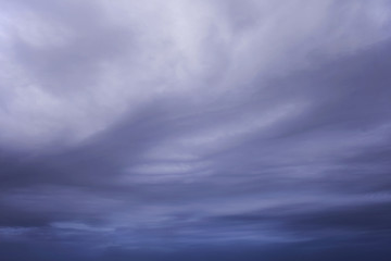 Fototapeta na wymiar Blue purple clouds with white gleams and soft wavy texture