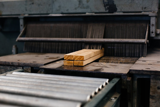Wood emerging from cutting machine