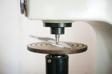 Engraving machine engraving on knife blade, close-up