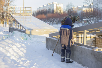 Two workers repairing the roof of the winter underpass