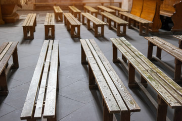 Old wooden benches. Benches on church floor. Welcome to the God's temple.