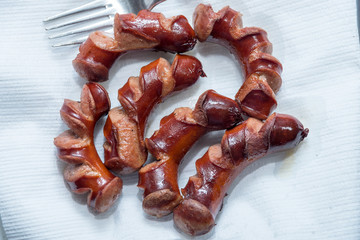 juicy grilled sausages in a pan