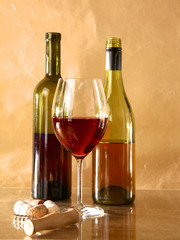 on the table a bottle of wine and glass