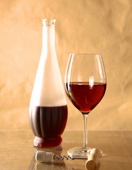 on the table a bottle of wine and glass