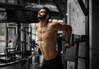 Shirtless athlete working hard at the gym.
