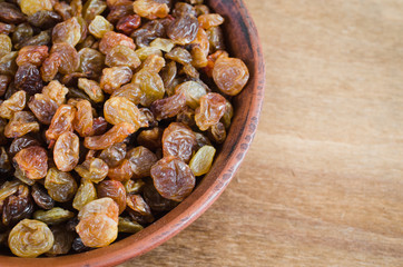 Dried Organic Raisin in Bowl on Wooden BackgroundClose-up.