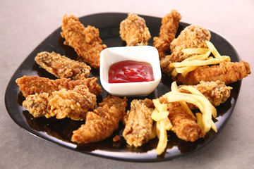 Grilled chicken on a plate standing the wooden table