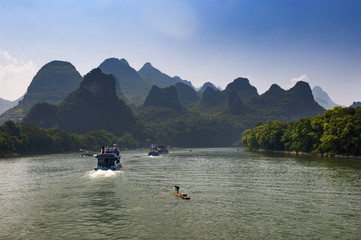 Passenger boats and rafts in the Li River in the Guagxi Region in Chia; Concept for travel in China