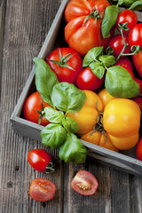 Fresh tomatoes in wooden box