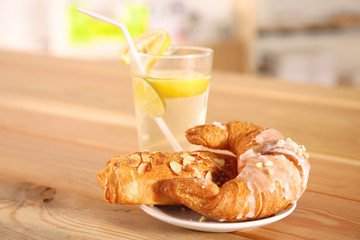 Croissant in the plate on the table
