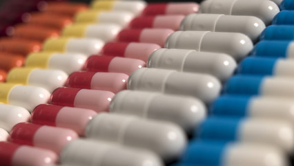 Obraz premium multicolored capsules neatly stacked in a row