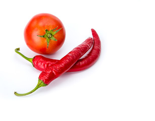Isolated ketchup ingredients. Fresh tomatoes and hot peppers isolated on white background