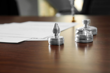 Metal stamps and ink pad on wooden table