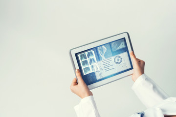 Close of female doctor hands working with tablet pc computer