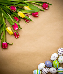 Fototapeta na wymiar Eastern egg, tulips on brown wrapping paper