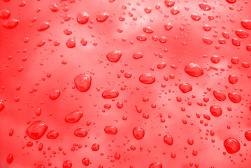 Rain drops on red background