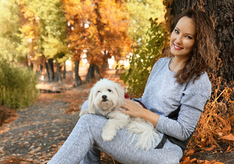 Woman walking with cute dog in park