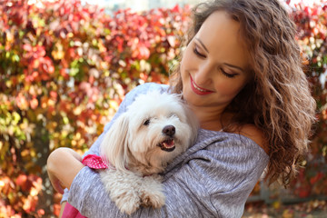 Woman walking with cute dog in park