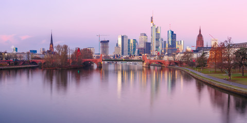 Fototapeta na wymiar Picturesque panoramic view of business district with skyscrapers and mirror reflections in the river at sunrise, Frankfurt am Main, Germany