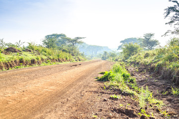 African landscape - dirt road through savanna, Kenya
