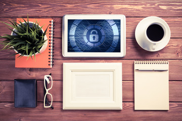 Web security and technology concept with tablet pc on wooden tab