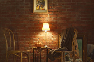 Modern room interior with chairs on brick wall background