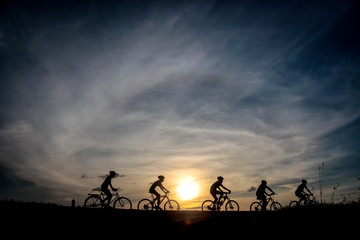 silhouette of bicycle rider at sunset