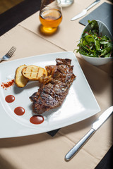 Steak with grilled potatoes with salad side
