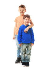 Cute little brothers standing on white background